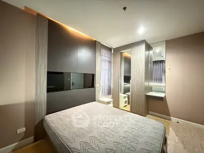 Modern bedroom with stylish design and ample natural light, featuring built-in wardrobe and cozy ambiance.