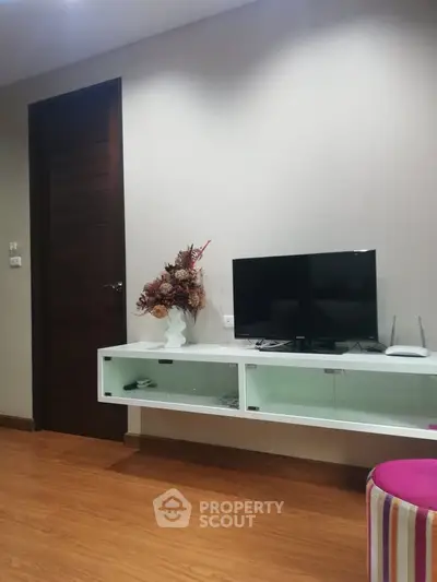 Modern living room with wall-mounted TV and stylish decor