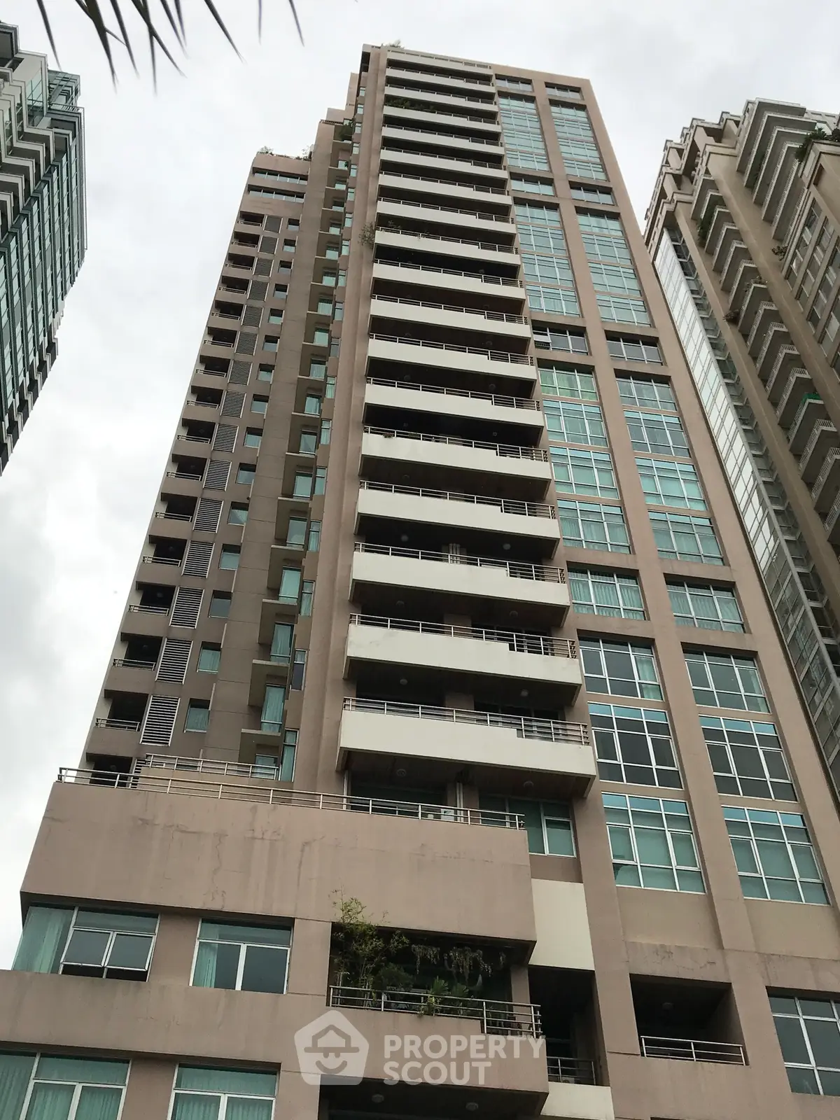 Stunning high-rise building with modern architecture and expansive windows in urban setting.