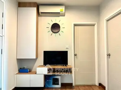 Modern living room with sleek furniture and wall-mounted air conditioner