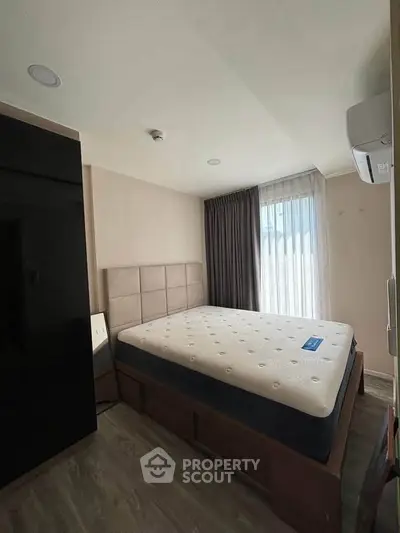 Modern bedroom with large window and stylish decor