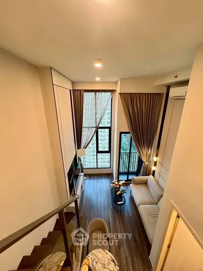 Luxurious high-ceiling living room with modern decor and stunning city view.