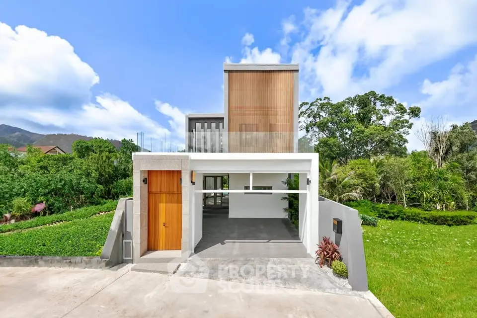 Modern architectural home with lush greenery and spacious driveway