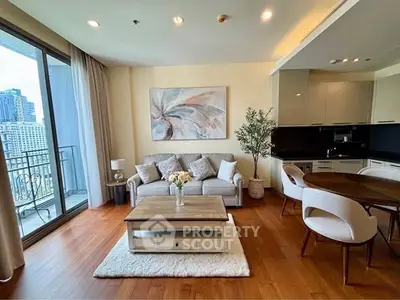 Luxurious living room with elegant decor and city view balcony in modern apartment.