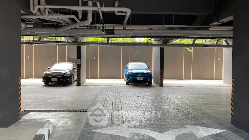 Modern parking area with two cars and clear directional signage