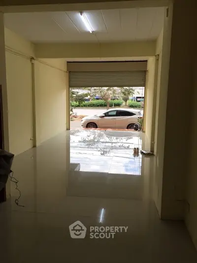 Spacious open garage with polished floors and street view