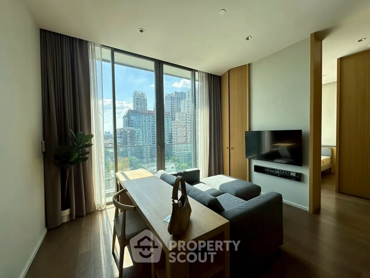 Modern living room with city view, stylish furniture, and natural light.