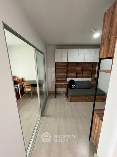 Modern compact bedroom with wooden accents and sliding glass door