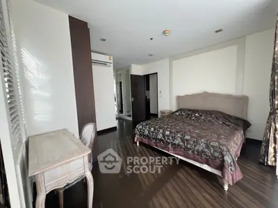 Spacious bedroom with elegant decor and natural light