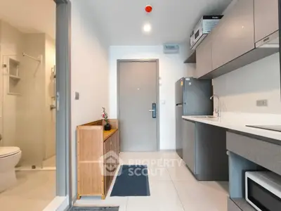 Modern apartment interior with sleek kitchen and bathroom, featuring minimalist design and neutral tones.