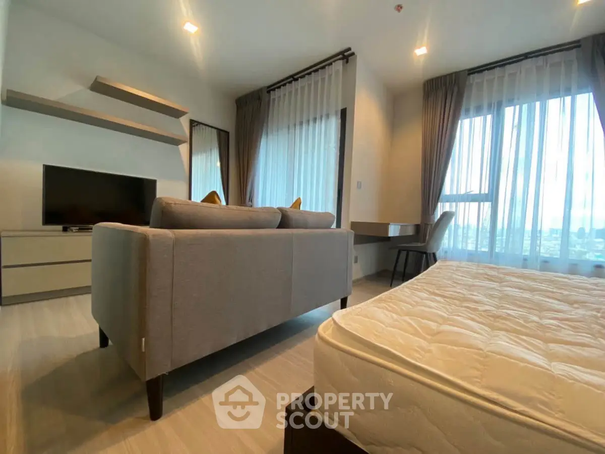 Modern living room with stylish furniture and large windows offering natural light.