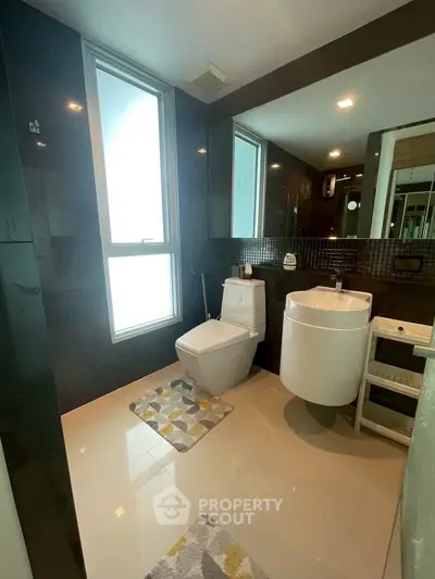 Modern bathroom with sleek fixtures and large window for natural light.