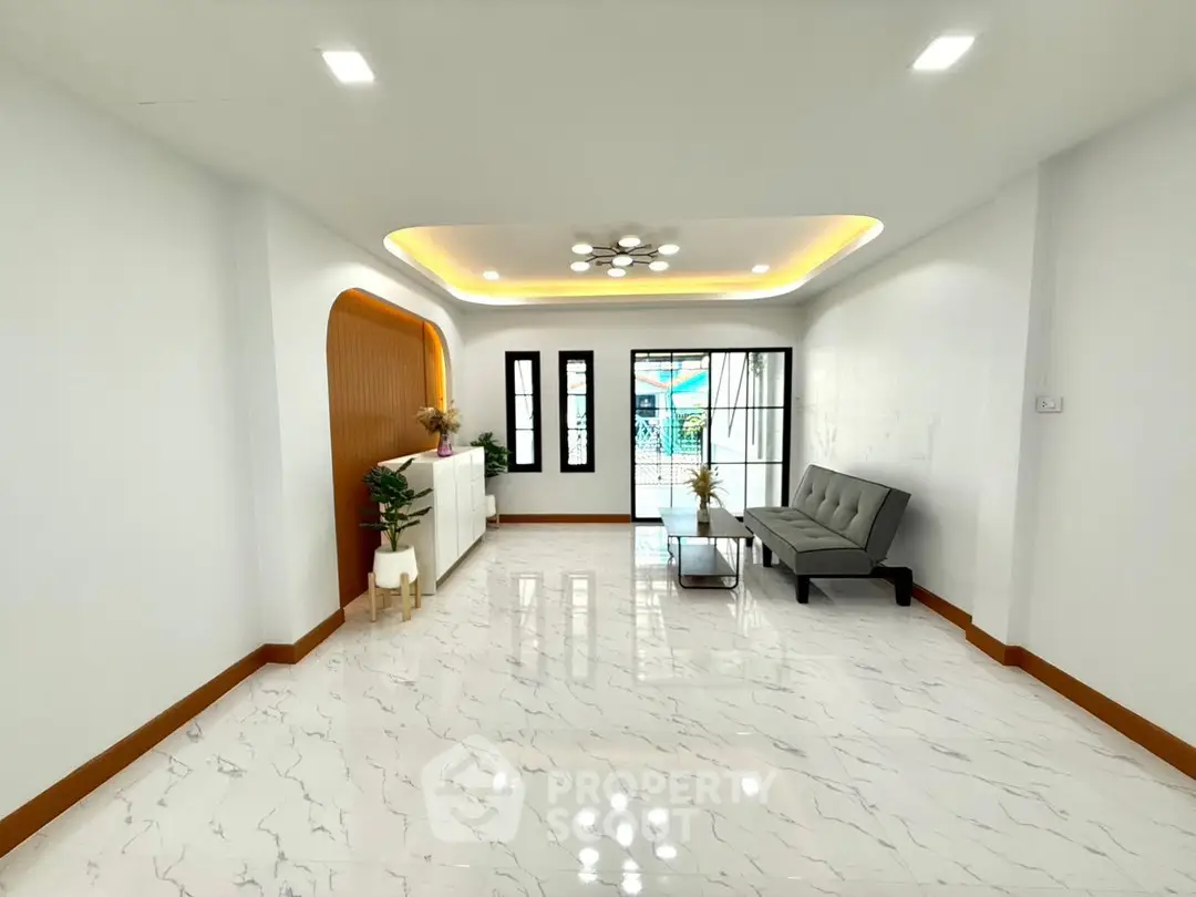 Spacious modern living room with elegant marble flooring and stylish lighting