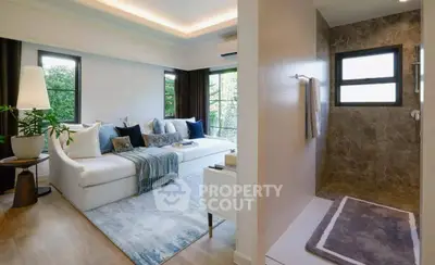 Modern living room with cozy sectional sofa and adjacent stylish bathroom