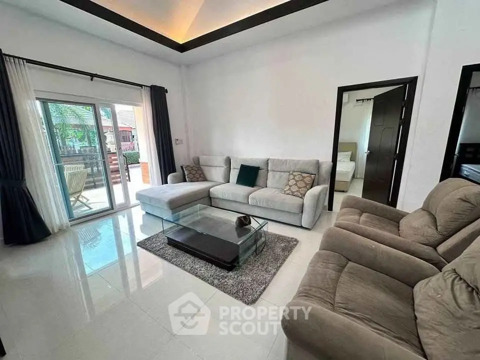Spacious living room with modern furniture and access to outdoor patio