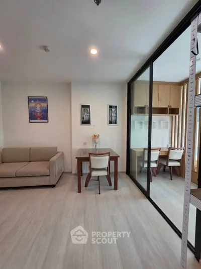 Modern living room with glass partition and stylish furniture