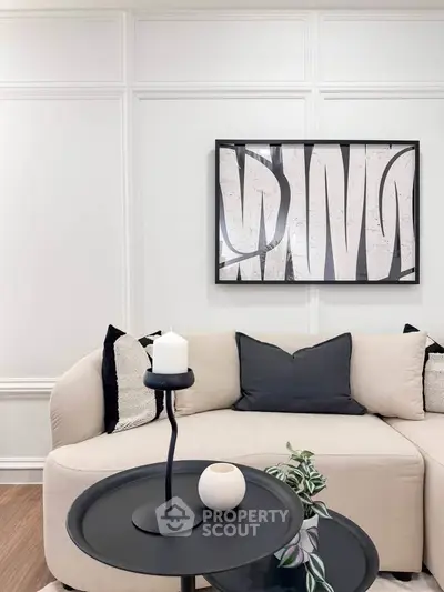 Elegant living room with modern art and cozy seating, perfect for relaxation and style.