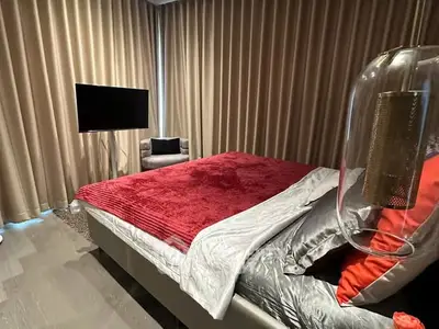 Luxurious bedroom with plush red bedding and modern decor