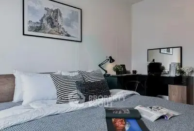 Modern bedroom with stylish decor and workspace, perfect for comfort and productivity.