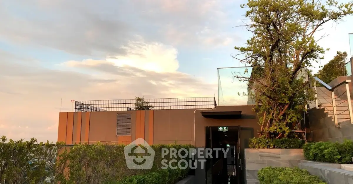 Stunning rooftop garden with panoramic views and lush greenery at sunset.