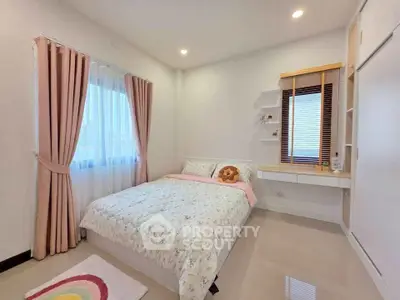 Cozy bedroom with floral bedding and natural light, perfect for relaxation.