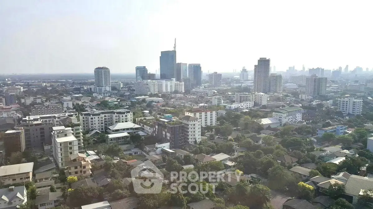 Panoramic cityscape view showcasing urban skyline and residential buildings.