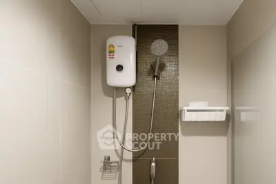 Modern bathroom with sleek shower and water heater, featuring elegant tile design.