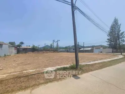 Expansive vacant land ready for development, boasting clear skies and potential for custom real estate projects, located in a serene neighborhood.