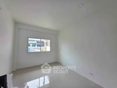 Bright empty room with large window and tiled floor, ideal for customization.