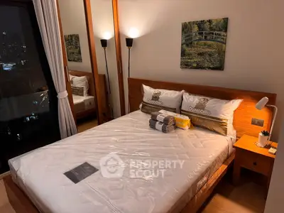 Cozy bedroom with city view, featuring a comfortable bed and elegant decor, perfect for urban living.