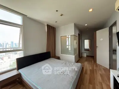 Spacious bedroom with city view and modern design in high-rise apartment