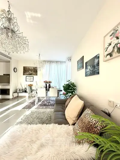 Luxurious living room with elegant chandeliers and plush decor