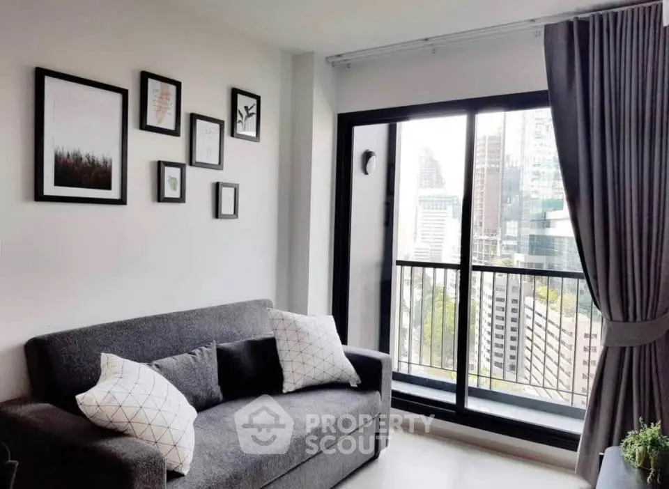 Modern living room with city view and stylish decor in high-rise apartment.