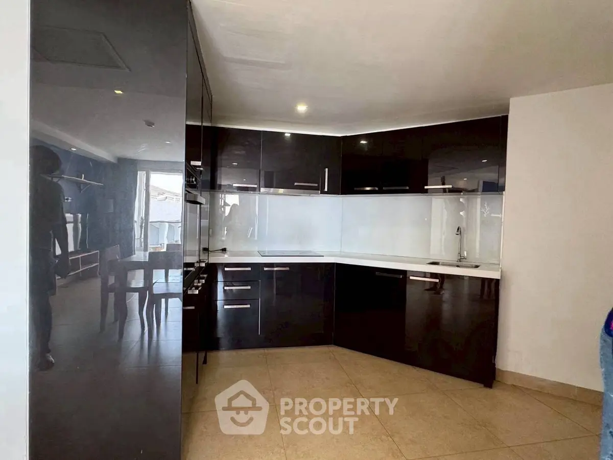 Modern kitchen with sleek black cabinets and open layout design