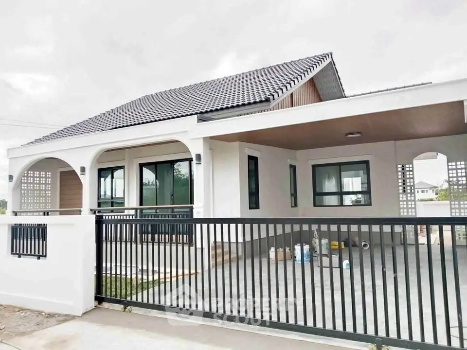 Modern single-story house with sleek design and spacious carport, featuring large windows and a stylish roof.