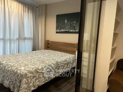 Cozy bedroom with stylish decor and ample natural light, featuring a comfortable bed and modern furnishings.