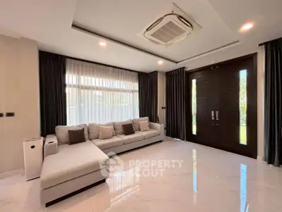 Spacious modern living room with sleek design and large windows for natural light.
