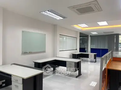 Modern office space with sleek desks and bright lighting, ideal for productivity.