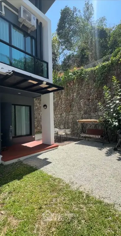 Charming outdoor patio with lush greenery and modern architecture, perfect for relaxation and entertaining.