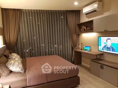 Modern bedroom with city view, featuring stylish decor and built-in desk area.