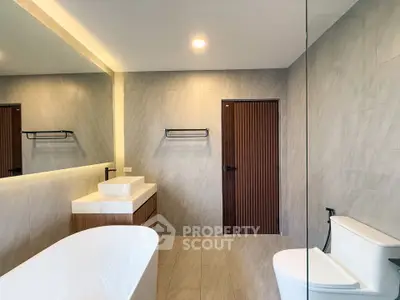 Modern bathroom with elegant fixtures and freestanding bathtub