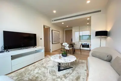 Modern living room with sleek furniture and open kitchen layout