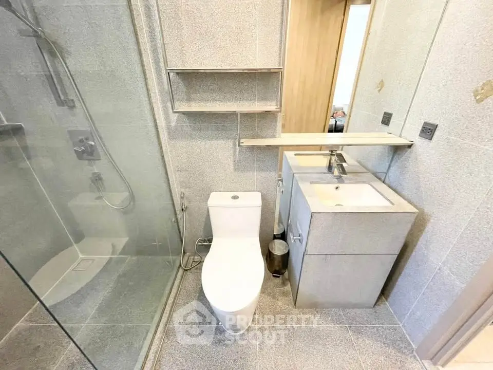 Modern bathroom with glass shower and sleek fixtures