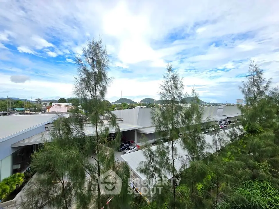 Scenic view of modern building with lush greenery and clear blue sky