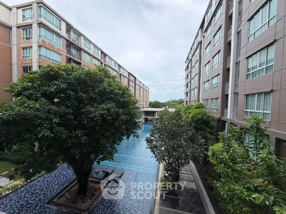 Luxurious condominium with stunning pool view and lush greenery, perfect for modern living.
