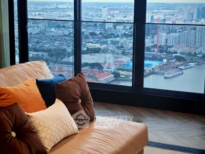 Luxurious living room with stunning city and river view from high-rise apartment window.