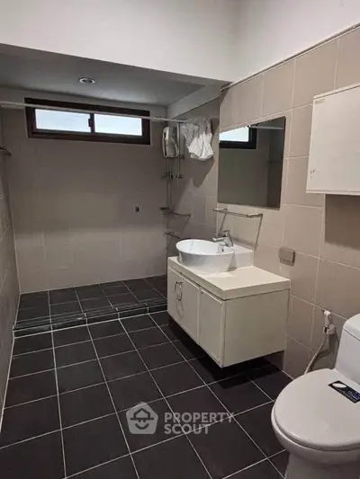 Modern bathroom with sleek fixtures and neutral tiles, perfect for a contemporary home.