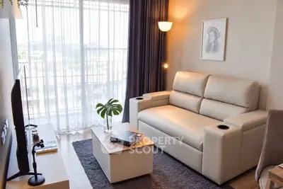 Modern living room with cozy sofa and natural light from large window