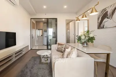Modern living room with elegant decor and open layout, featuring a cozy sofa and stylish lighting.