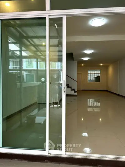 Spacious modern interior with sleek tiled flooring and ample natural light, perfect for versatile living or office space.